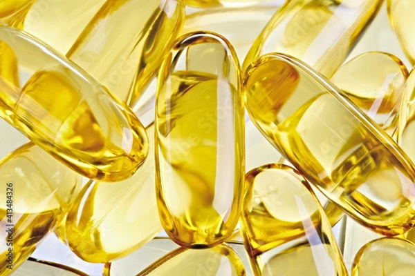 Obraz Fish oil concentrate in a soft gelatin capsule to support human health. Omega3 close-up on a white background.