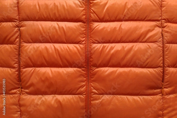 Fototapeta Down jacket fabric background, orange puffer jacket texture