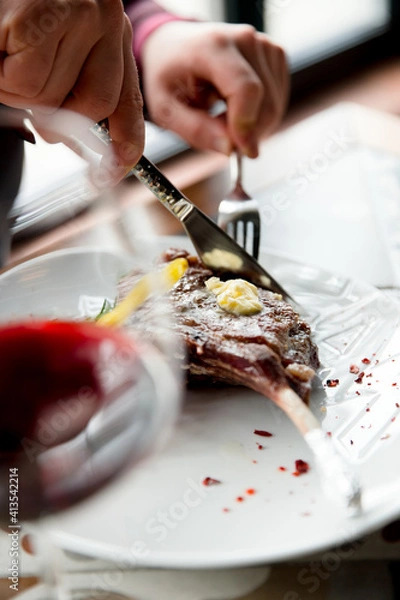 Fototapeta preparing steak on a plate