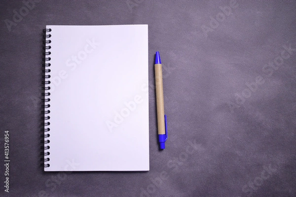 Fototapeta white notebook with eco-friendly pen and space for text on black textured background