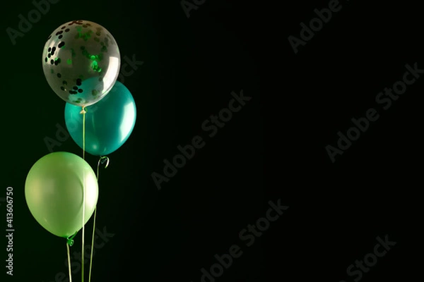 Fototapeta Concept of St. Patrick. Green balloons on dark background, copy space for text
