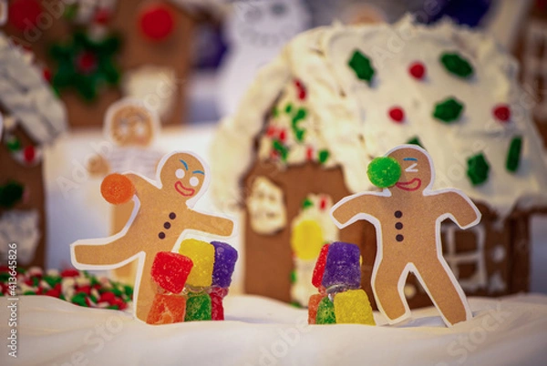 Fototapeta Funny Diorama of Two Gingerbread People having a Gumdrop Fight in Front of a Gingerbread Village