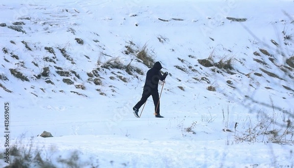 Fototapeta a man on cross-country skis somewhere on the trail near the Narew River in Poland