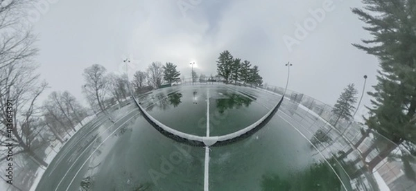 Fototapeta Panorama of an Ice-Covered Tennis Court in the Winter on an Overcast Day