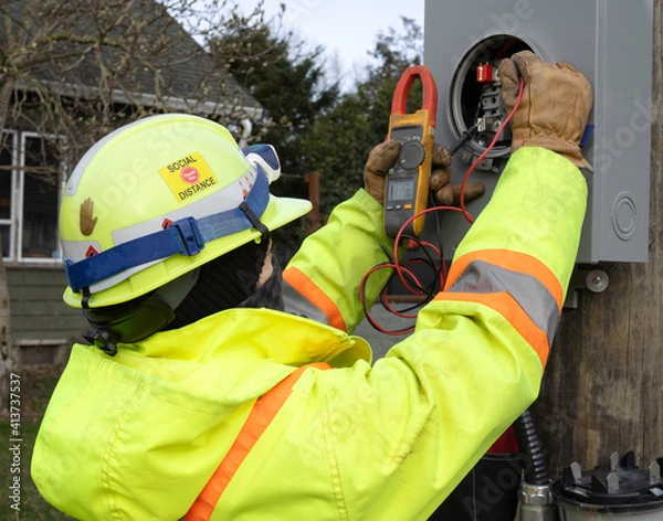 Obraz Female electrician using her meter