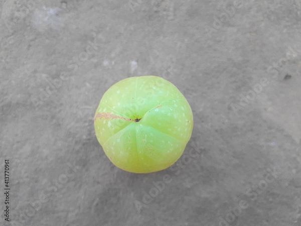 Obraz a beautiful green coloured amala's fruit on brown background, it's uses in production of medicine