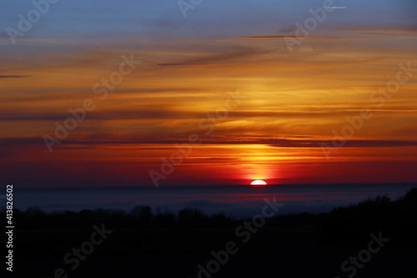 Obraz Dramatic sunset with reddish and golden colors.
