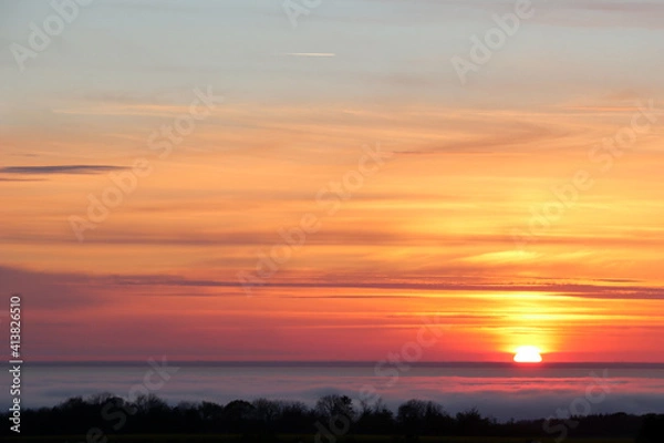 Obraz Atmospheric sunset over thin clouds