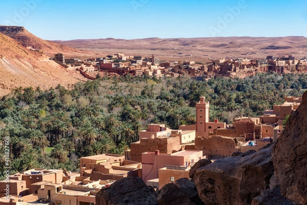 Fototapeta The Tinghir Oasis near Ait Ijjou, with the town of Tagounsa in background. Tinghir is one of the most attractive oasis in southern Morocco. Lush Palm trees cover about 30 miles along the Wadi Todgha