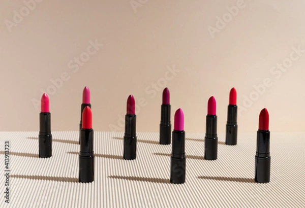 Fototapeta lipstick in different shades of red and pink colors on a corrugated background