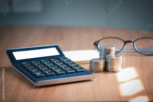 Fototapeta A calculator with white fields to put text on the table. Business concept for taxes, finance, loan calculate