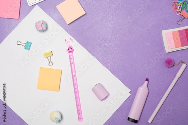 Fototapeta  Summer bright vivd Flat lay workspace. Mess of Stationary and keyboard on bright violet purple background, top view. Girly work desktop. School concept. 