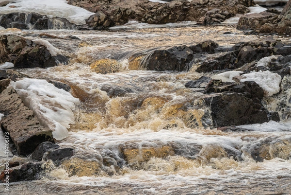 Fototapeta river with ice during spring with sunlight