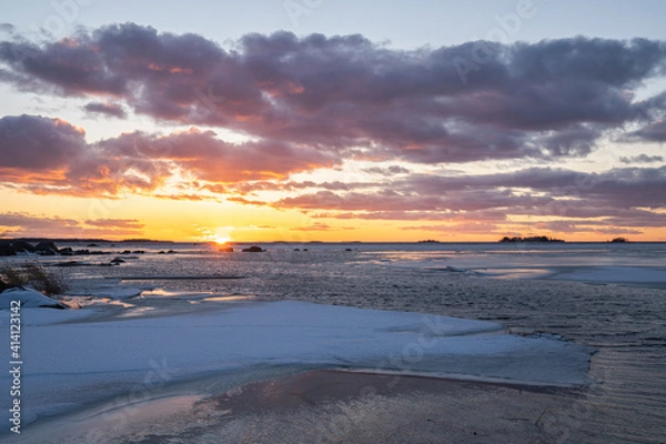 Fototapeta sunset over the sea with light reflections under the clouds
