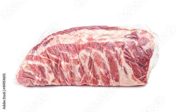 Fototapeta A piece of fresh pork meat in a vacuum package. Vacuum packaging raw fresh pork ribs isolated on a white background.