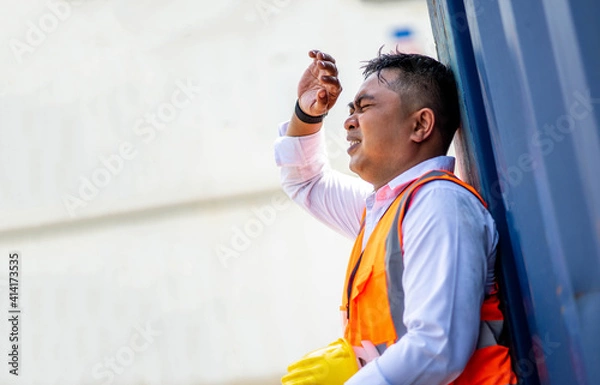 Obraz Factory worker man working in hot weather and he look tired from work.