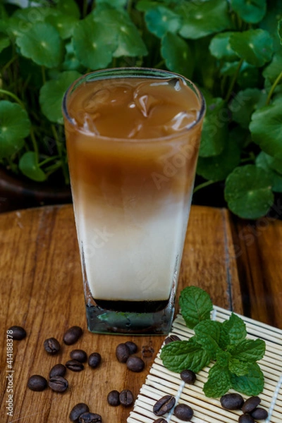 Fototapeta vietnamese iced coffee milk, Iced coffee is a type of coffee beverage served chilled, brewed simply pouring over ice or into ice cold milk.