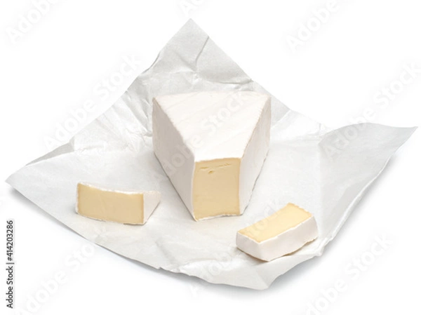 Obraz Brie cheese chunks on wrapping paper isolated on a white background