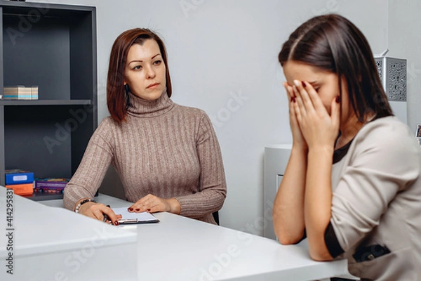 Fototapeta Appointment with a psychologist. Psychological problems. Cried woman with broken mental health.  The process of psychological correction of personality. Help for those in need. Depression concept
