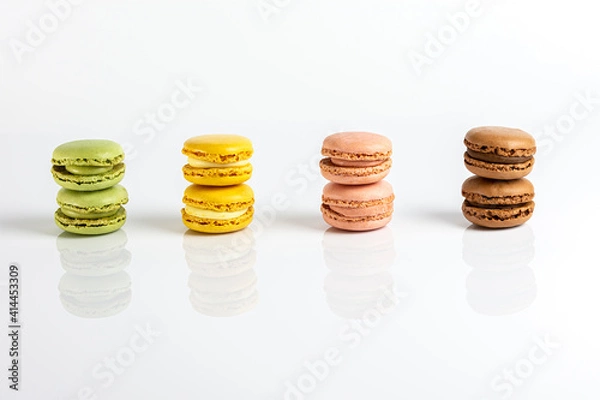 Obraz Multicolored macarons lined up on a white background