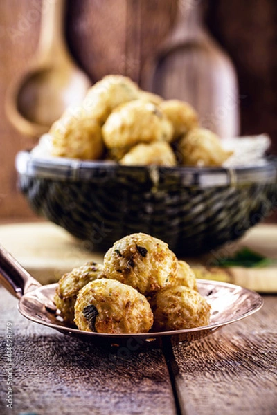 Fototapeta cod dumplings, fish meat dumpling in a slotted spoon, fried salty