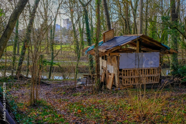 Fototapeta Dilapidated shack on the edge of a small river