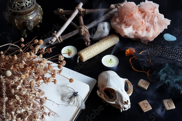 Fototapeta Magic ritual altar of the witch. Witchcraft ritual, fortune-telling for the future. Ritual skull of a cat, lighted charmed candles. Items for black magic. Salon providing esoteric services