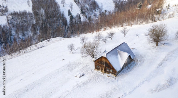 Obraz Aerial scenic rural view over Pestera village at the bottom of Piatra-Craiului Mountains during a freezing winter in Romania with authentic houses