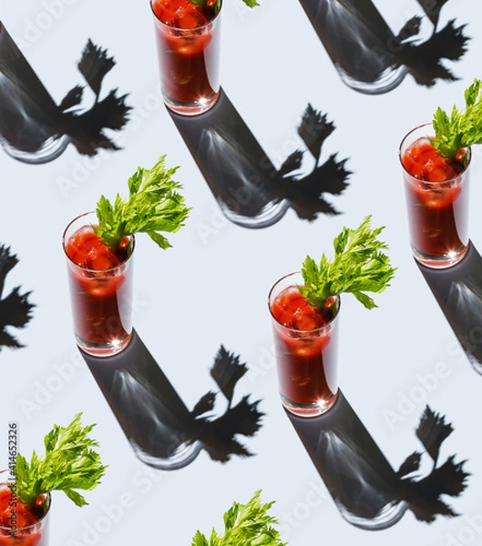 Fototapeta Bloody Mary cocktail with ice and celery on gray background Pattern
