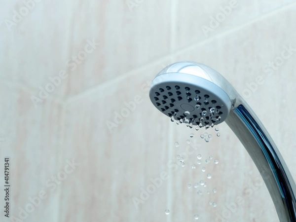 Fototapeta Shower head with low water stream. Broken shower in the bashroom