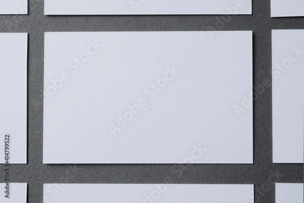 Fototapeta Blank white board, on a grey background white and blank card, symmetrical sheets, space for text