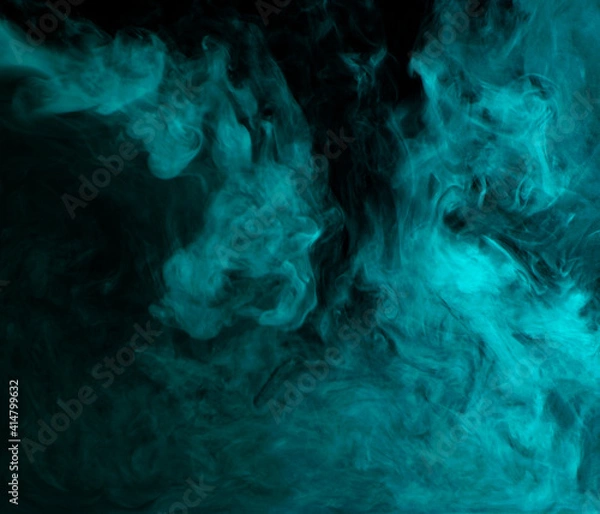 Fototapeta Abstract background of chaotically mixing clouds of turquoise smoke on a background of darkness