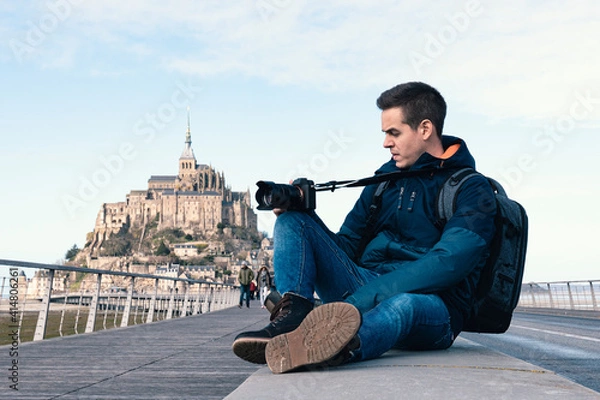 Obraz Sitting man taking photos