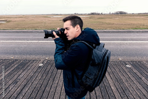 Obraz Man taking photos in the field