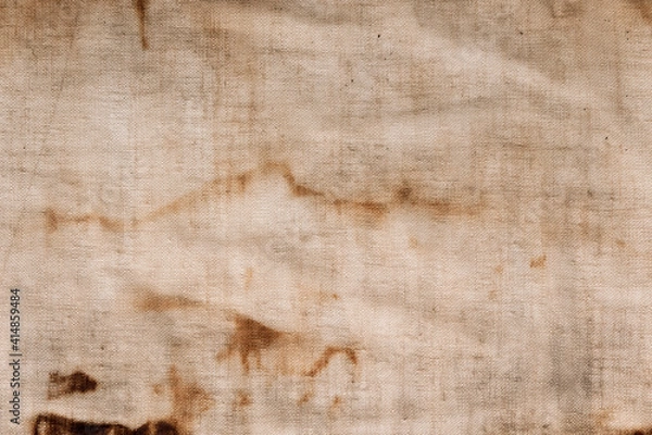 Fototapeta The texture of an old linen fabric, covered with dirt, rust and streaks. Background grange. Vintage rag.