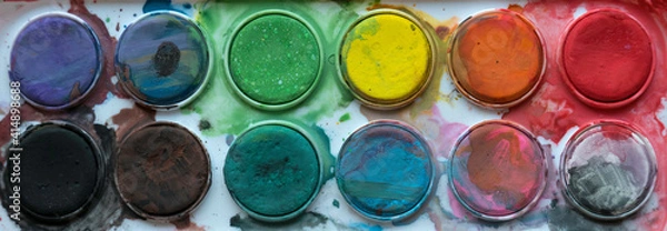 Fototapeta Close up view of messy colorful watercolor palette.