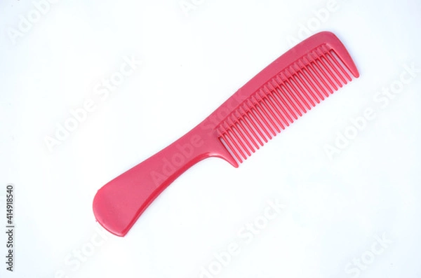 Fototapeta the maroon color comb isolated on white background.