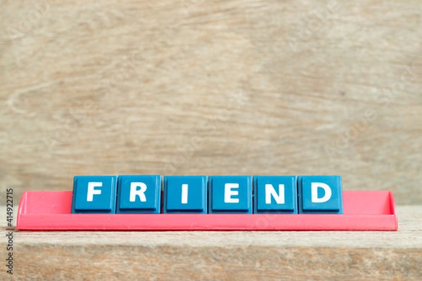 Obraz Tile alphabet letter with word friend in red color rack on wood background