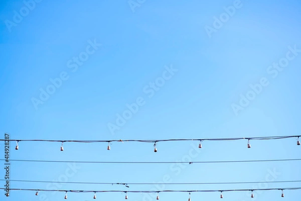 Fototapeta The bulbs are hung in long rows background sky , look beautiful in the morning