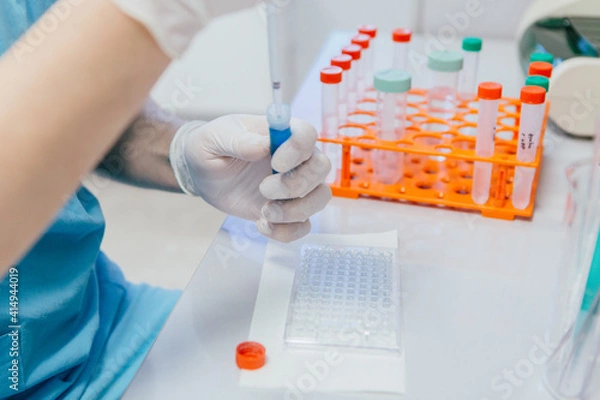 Obraz Hands with a test tube in biochemical laboratory