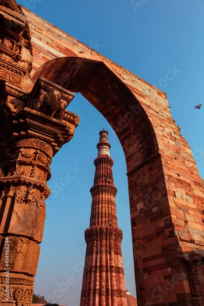 Fototapeta Qutub Minar a highest minaret in India standing 73 m tall tapering tower of five storeys made of red sandstone. It is UNESCO world heritage site at New Delhi, India