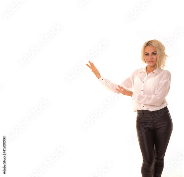 Fototapeta The blonde points to the empty space.