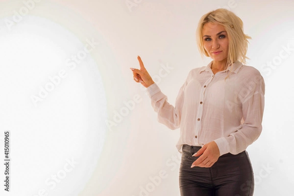 Obraz Blonde stands on a white background and poses.