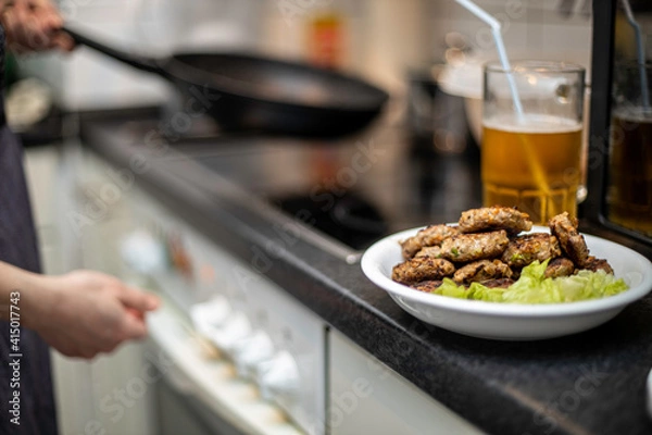 Fototapeta woman preparing mini hamburger over the kitchen table