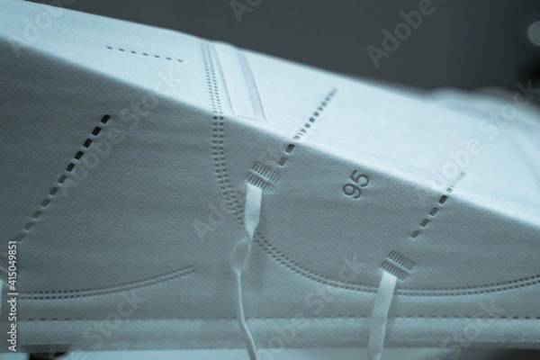 Fototapeta An N95 Mask is Automatically Folded on a Factory Production Line