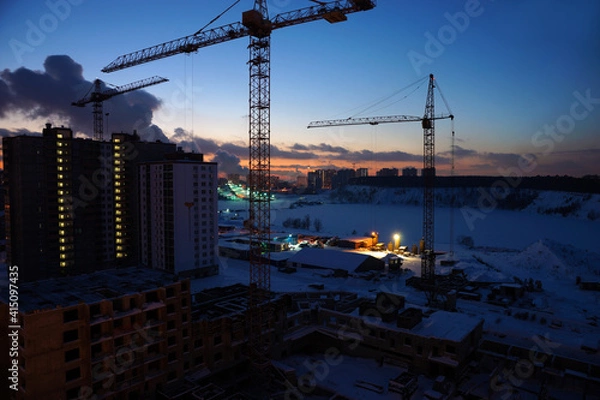 Fototapeta Night view of the construction site of a new house. Moscow region, Dzerzhinsky. January 2021.