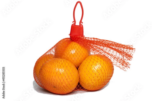 Obraz Fresh Oranges in Plastic Mesh Sack on White Background