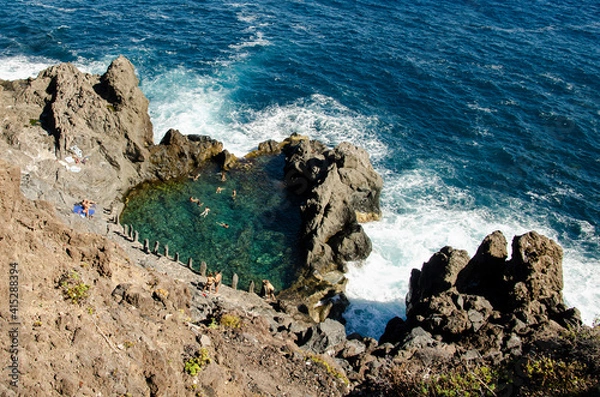Fototapeta Natural pool next to the ocean created by a volcanic eruption