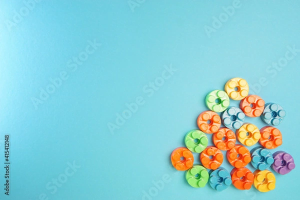 Fototapeta  Plastic building blocks isolated on blue background. Top view with copy space