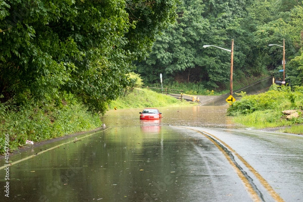 Obraz car driving on a  flooded road
